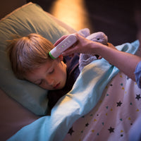 A Parent checking her child's temperature with a Withings Smart Thermometer - FitTrack Australia